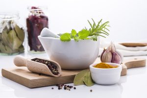 Herbs and spices displayed in jars, bowls, spoons for herbal medicine. Photo credit: Patrycja Tomaszczyk