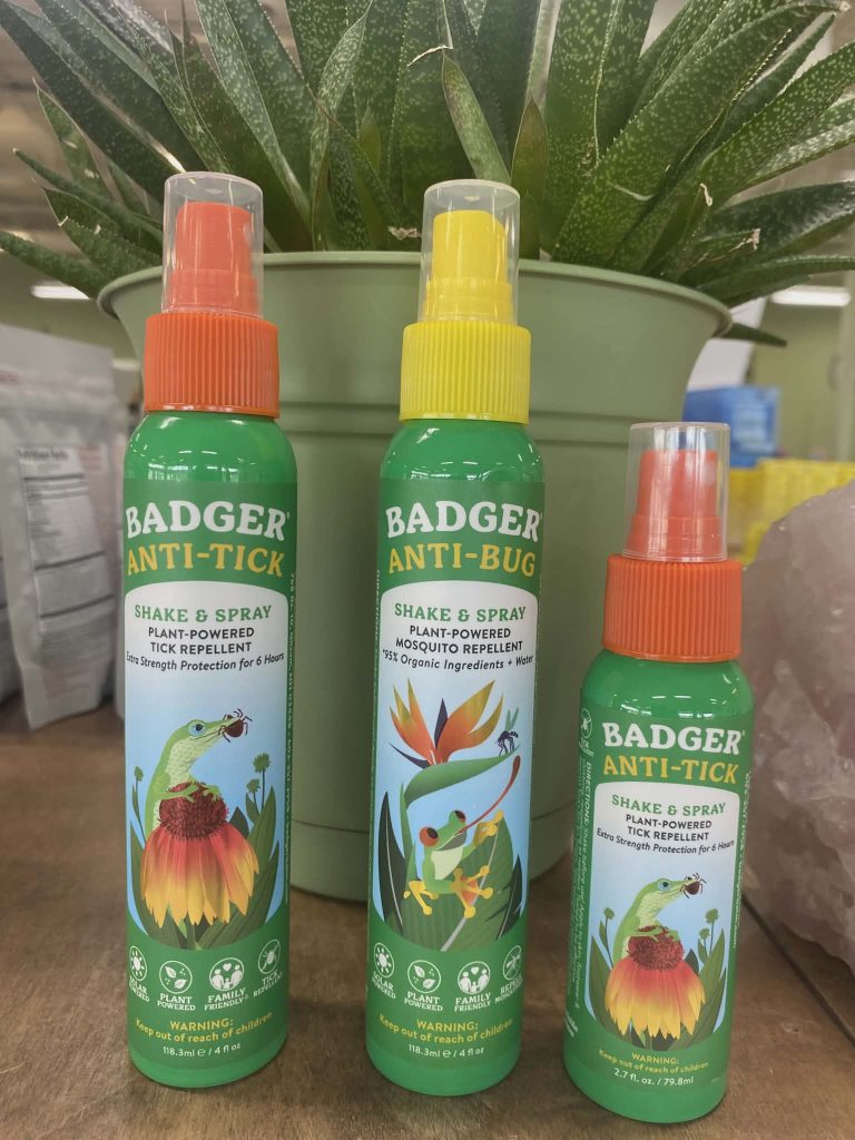 Display of anti-tick spray bottles in Rebekah's store.