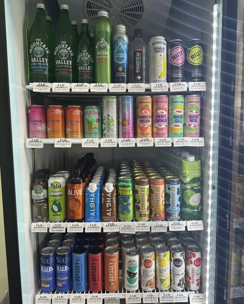 Upright cooler filled with wellness drinks for sale at Rebekah's.